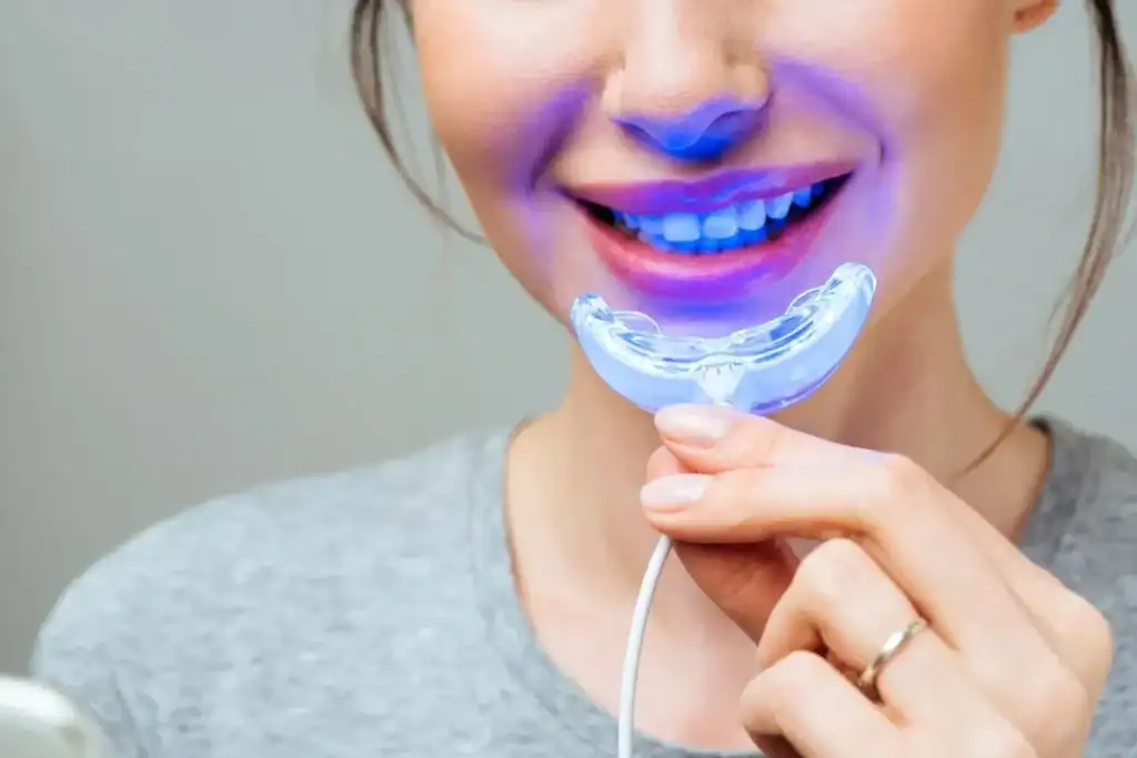 Woman using at-home BBlue Light Teeth Whitening Leamington Spa device for a brighter smile Abingdon